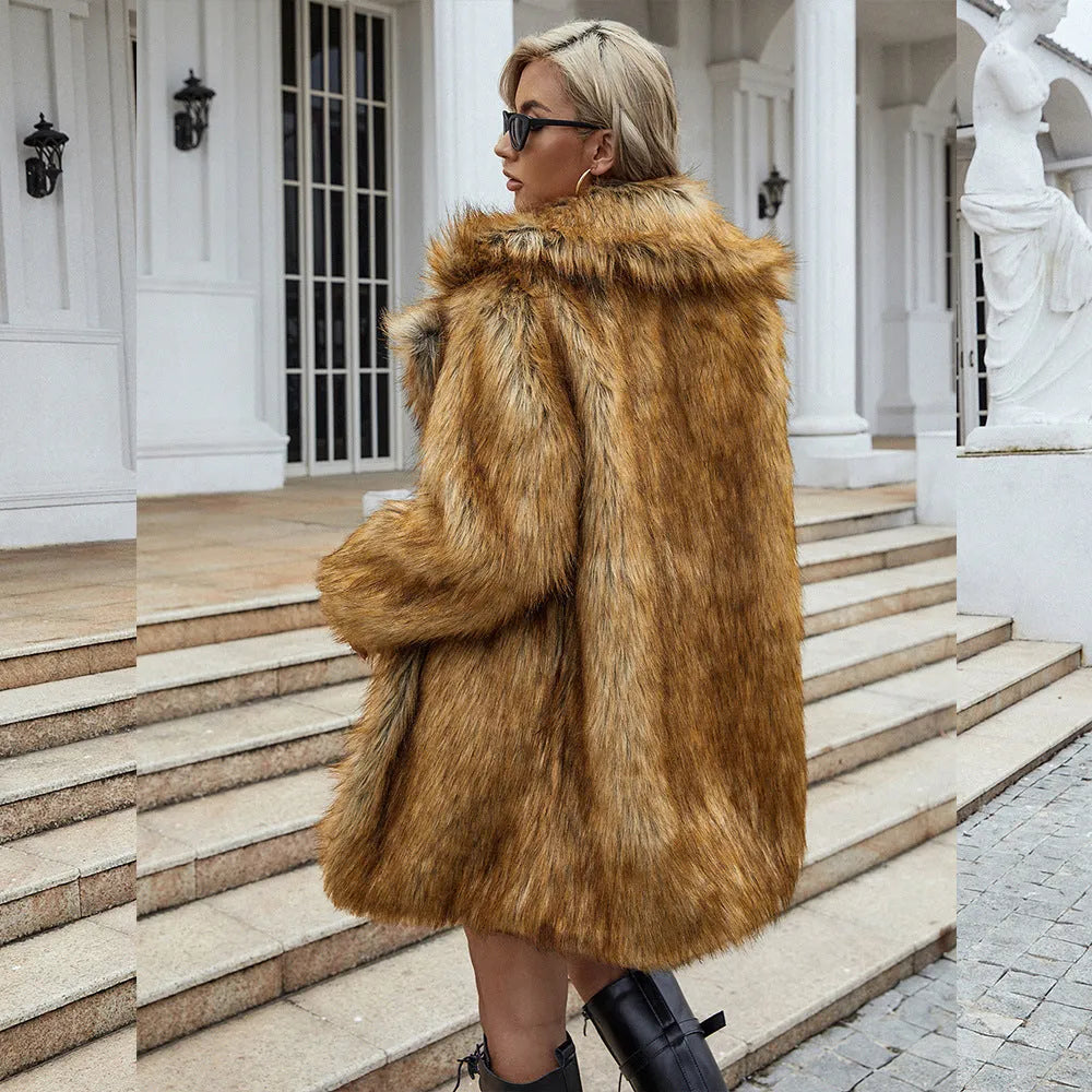 Yellow loose-fitting women's faux fur coat with regular sleeves on a hanger.