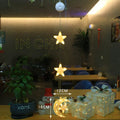 Set of three Christmas LED star window lights with suction cups on a glass window, warm glow, plastic housing, battery operated