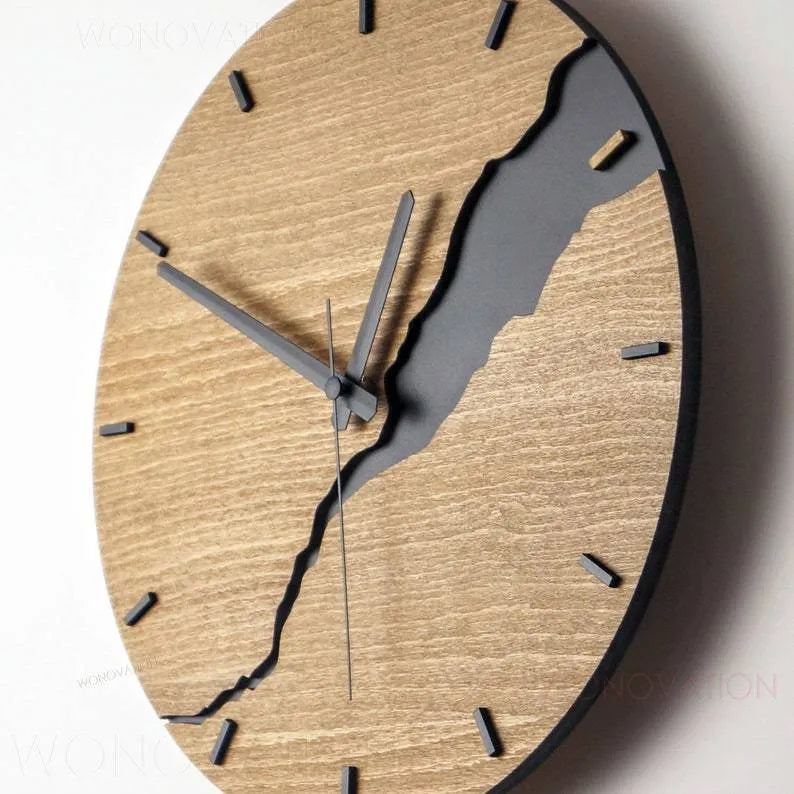 Modern wooden wall clock with a creative crack effect finish on its face, showing a silent second hand.