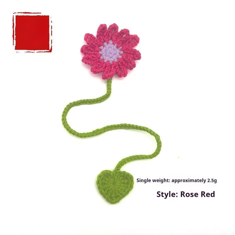 Hand-crocheted daisy wool bookmark with flexible wire core in yellow, pink, and light purple colours.