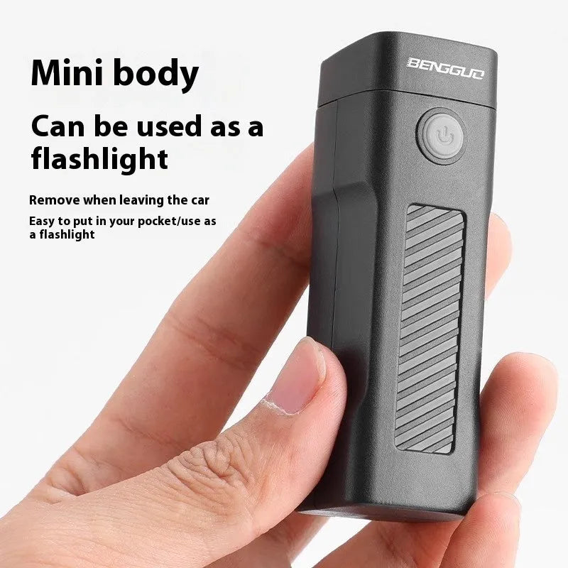 A black USB rechargeable bicycle headlight with a quick-release strap mount on a handlebar.