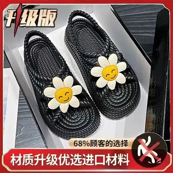 Beige PVC sandals with flower embellishments and a round toe, on a non-slip sole.