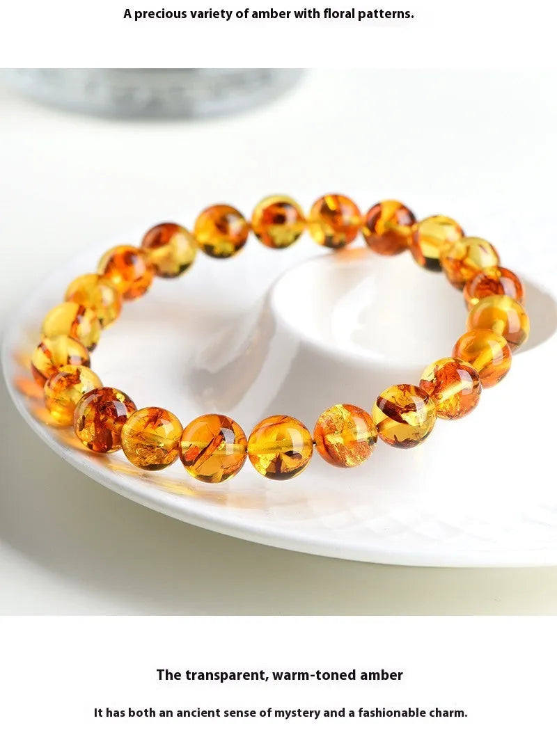 Natural yellow amber bracelet with piebald spots, showing geometric beads on a wrist.