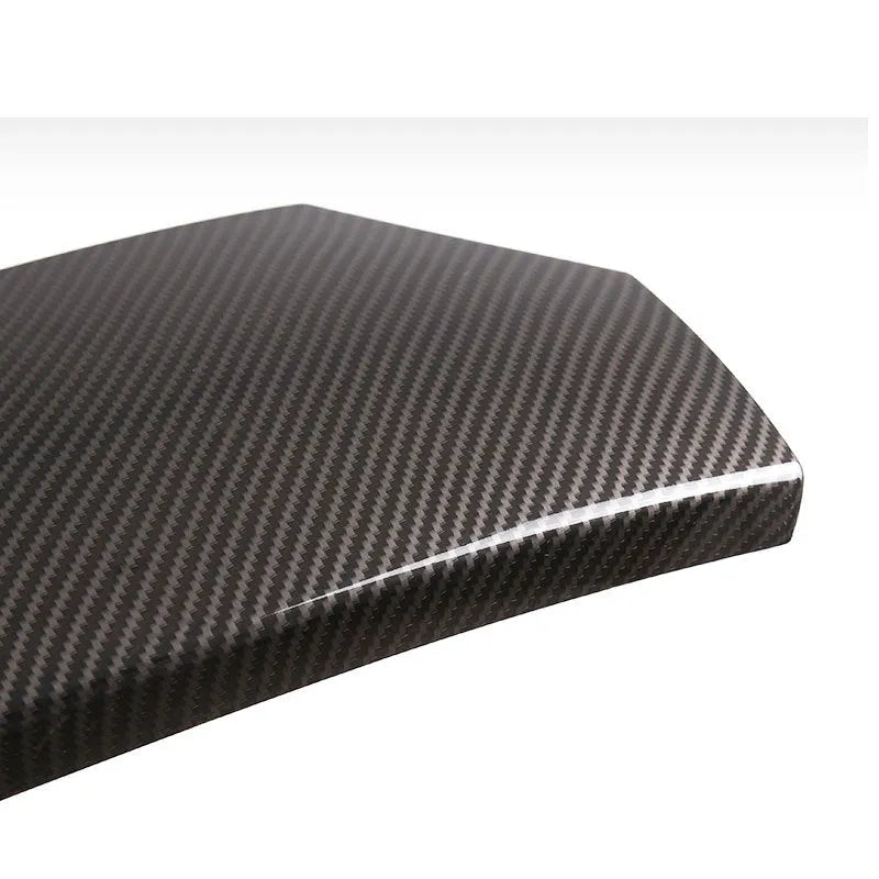 Set of three black ABS car armrest box protective covers with a diagonal carbon fibre weave pattern and shiny finish.