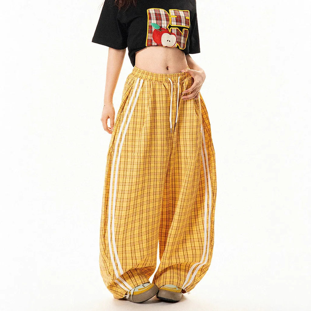 Blue loose straight wide leg polyester trousers with pockets and mid-waist design on a model