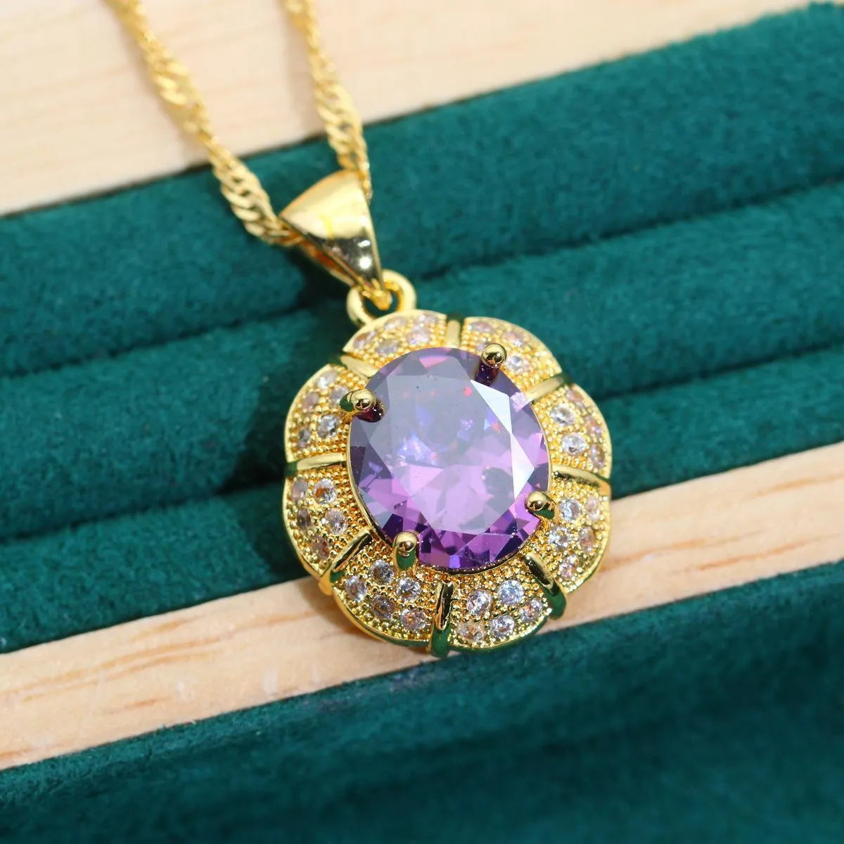 18k gold plated jewellery set with multi-colour zircon stones including necklace, earrings, bracelet, and ring on a display.