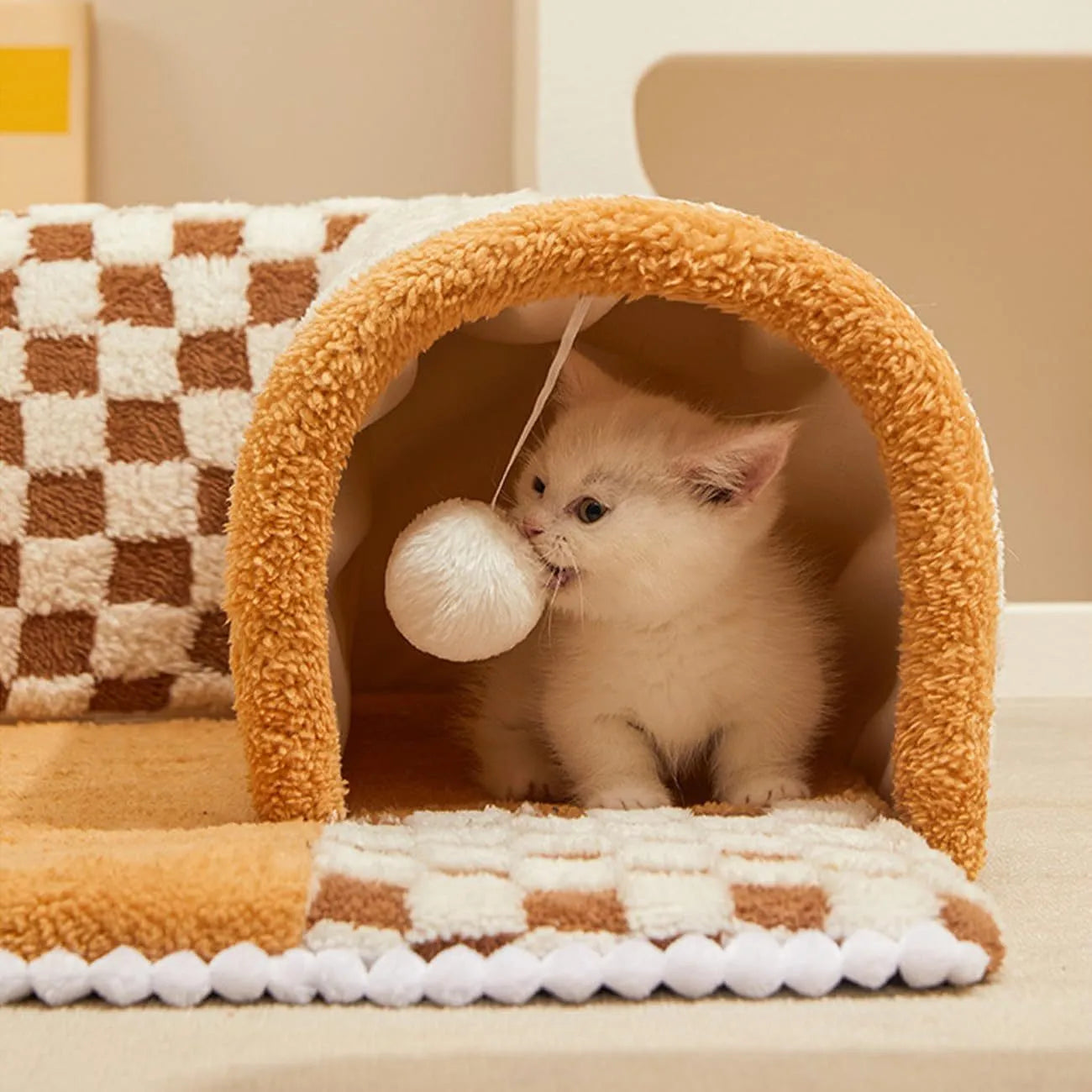 Coffee coloured plush fan-shaped pet bed with attached tunnel, showing anti-slip base.