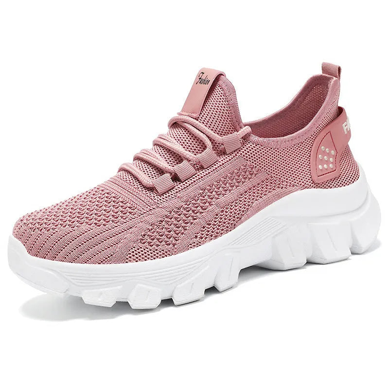 Women's white Flyknit running sneakers with thick PVC sole and lace-up front.