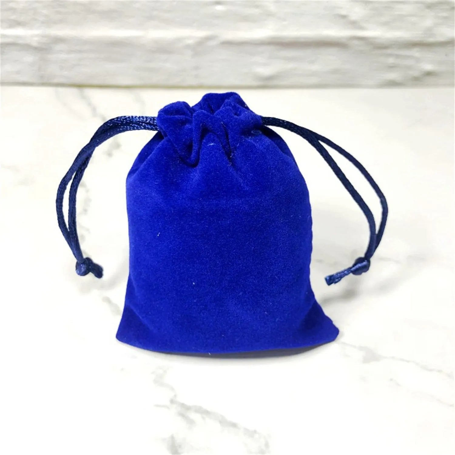 Flannel drawstring bag with beam opening, available in multiple colours and sizes for storage or gifting