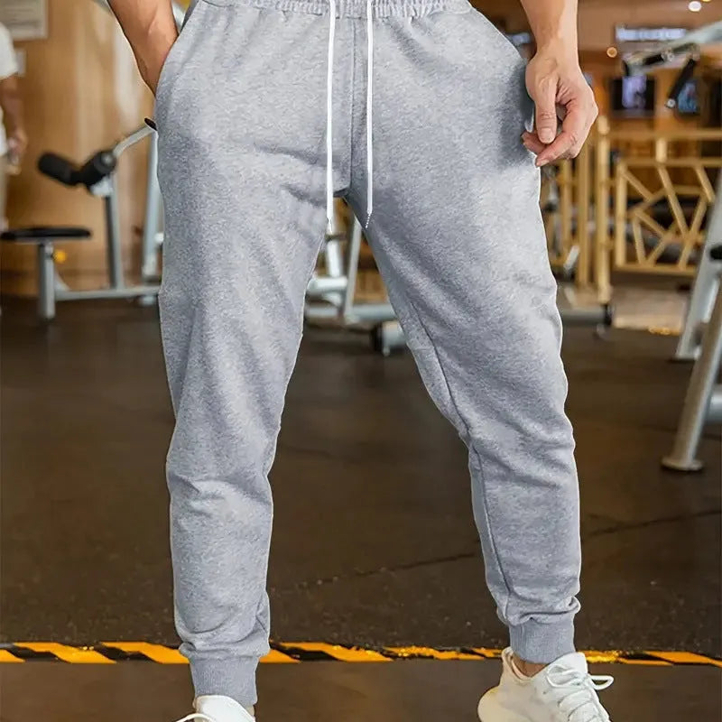 Men's loose-fit linen-style casual trousers with an elastic drawstring waist, shown in a neutral colour.
