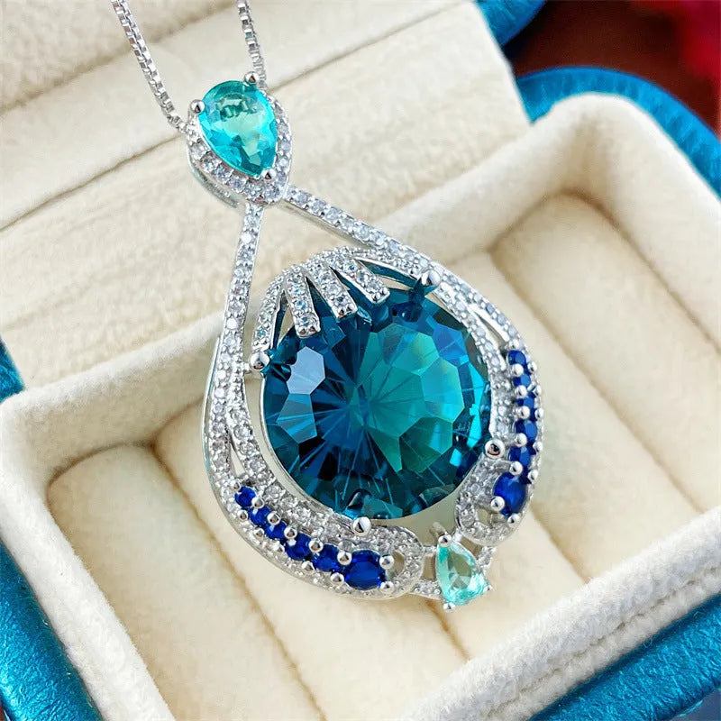 Geometric pendant necklace with blue fireworks cut gemstones on water wave chain