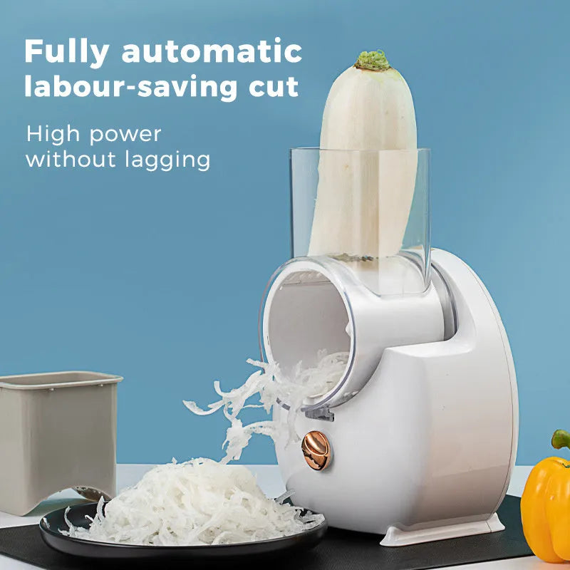 White electric vegetable slicer with suction base and multiple blades on a kitchen counter.