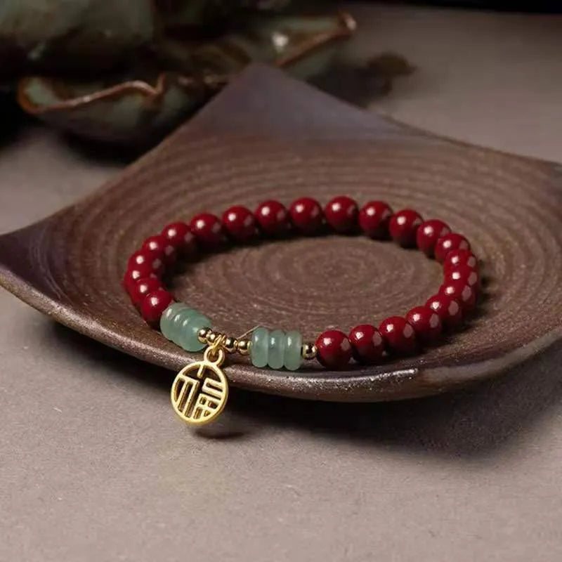 Handcrafted gold cinnabar bracelet with wave design in pumpkin cinnabar colour