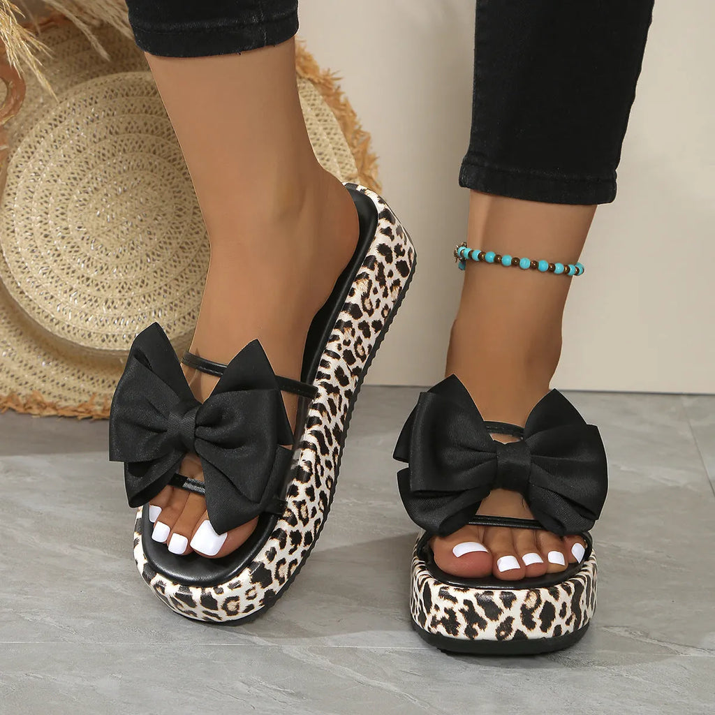 Women's leopard print beach slippers with thick rubber sole and round-toe design in black and white