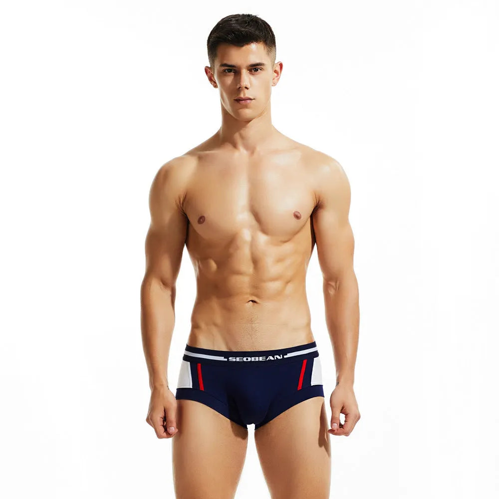 Men's low waist cotton boxers in red, dark blue, or light grey, showing hip lifting design.