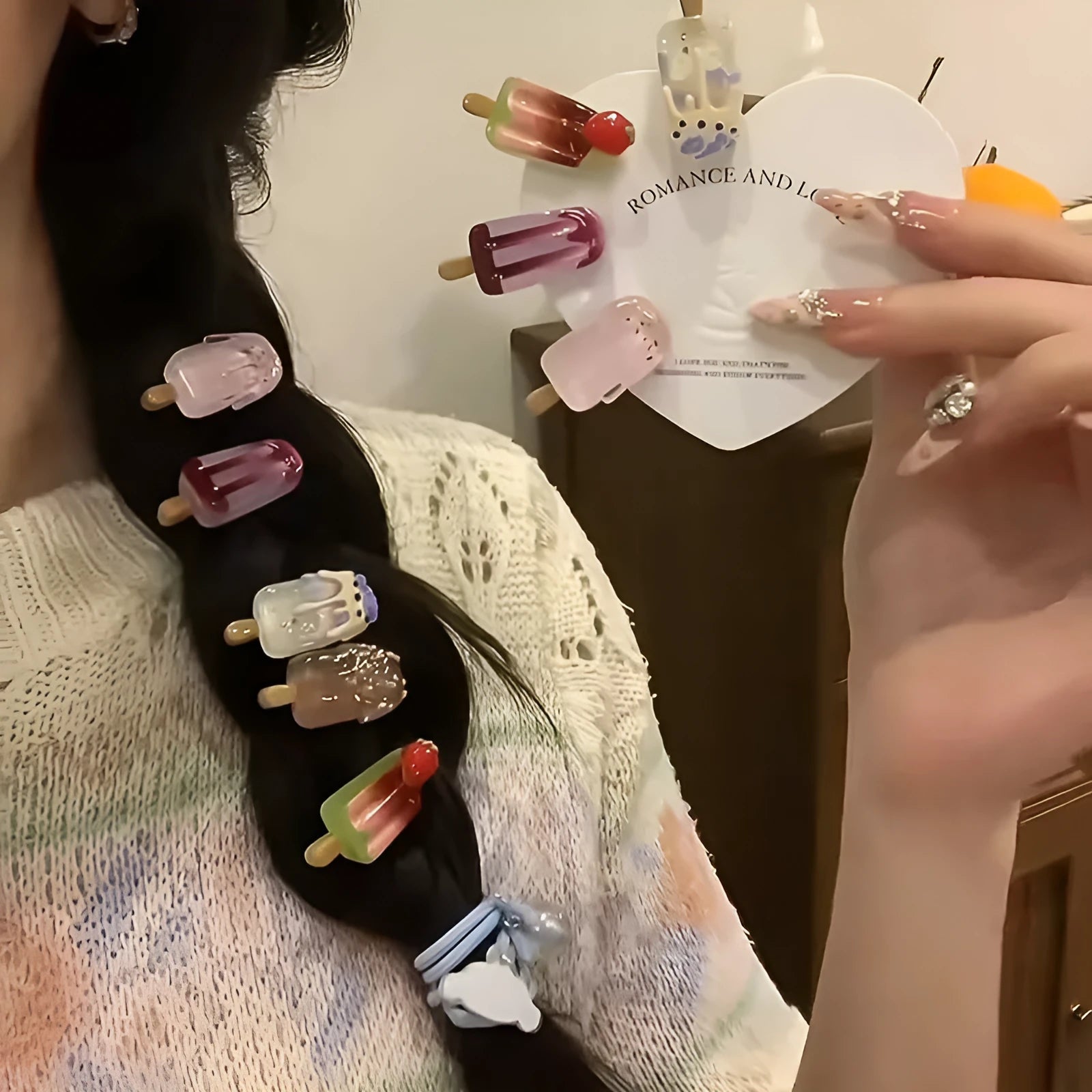 A resin hair clip shaped and coloured like a cartoon ice cream barrette, shown on a side clip.
