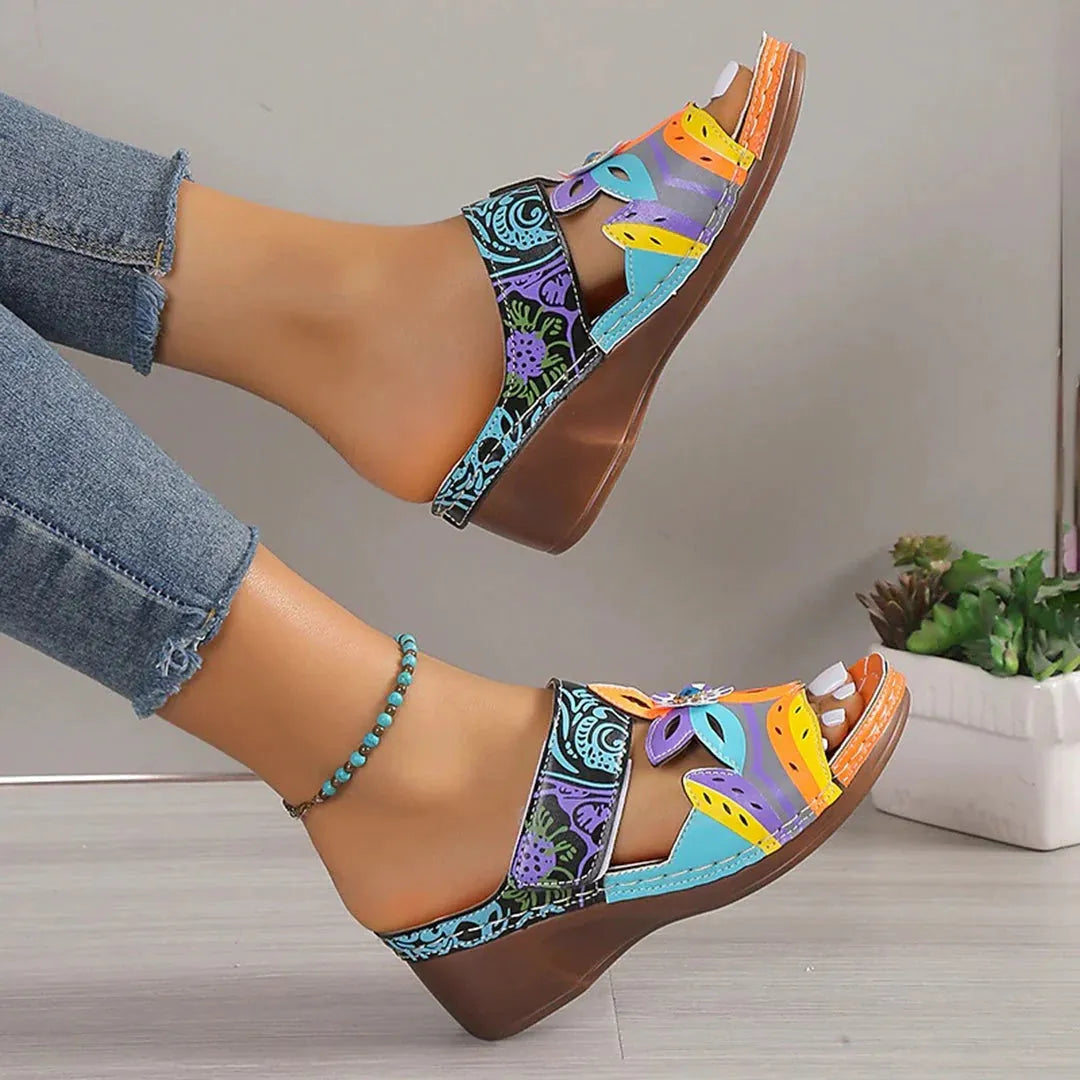 Ethnic slope and totem design slippers in cowhide with a round toe and rubber sole, shown in multiple colours.