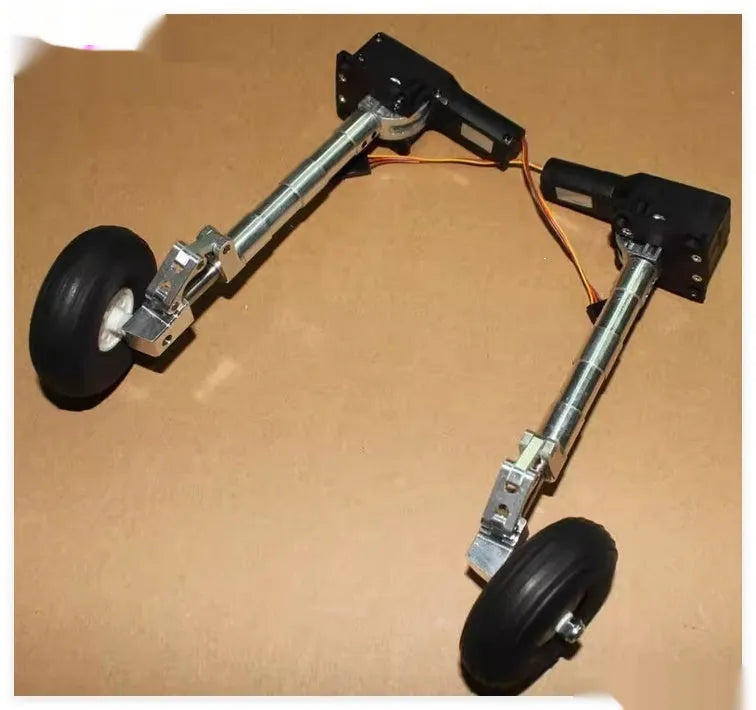 Pair of silver alloy retractable landing gear for RC models with wheels, shown at an inclined kneeling angle.