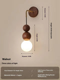 Wood and copper cylindrical wall lamp with suspension wire, showing Walnut and copper colour variants.