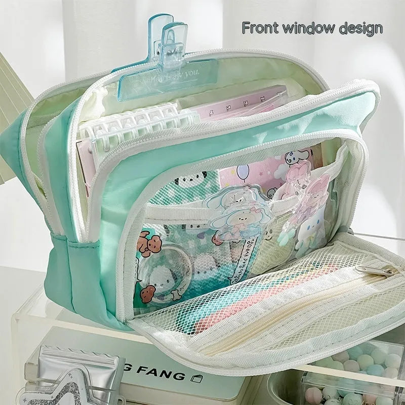 Double layer zippered pencil case in blue with an attached carry handle, showing two compartments.
