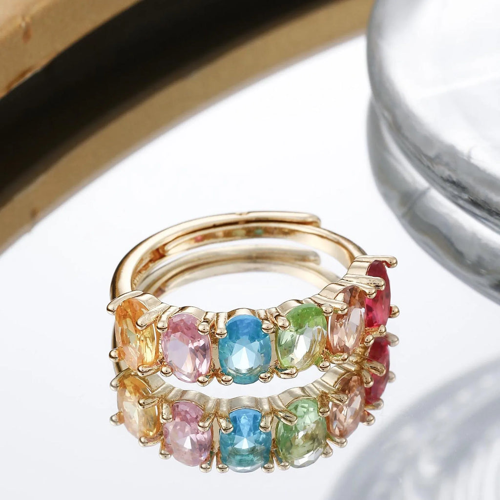 Gold-coloured adjustable zircon ring with simple retro design on a white background