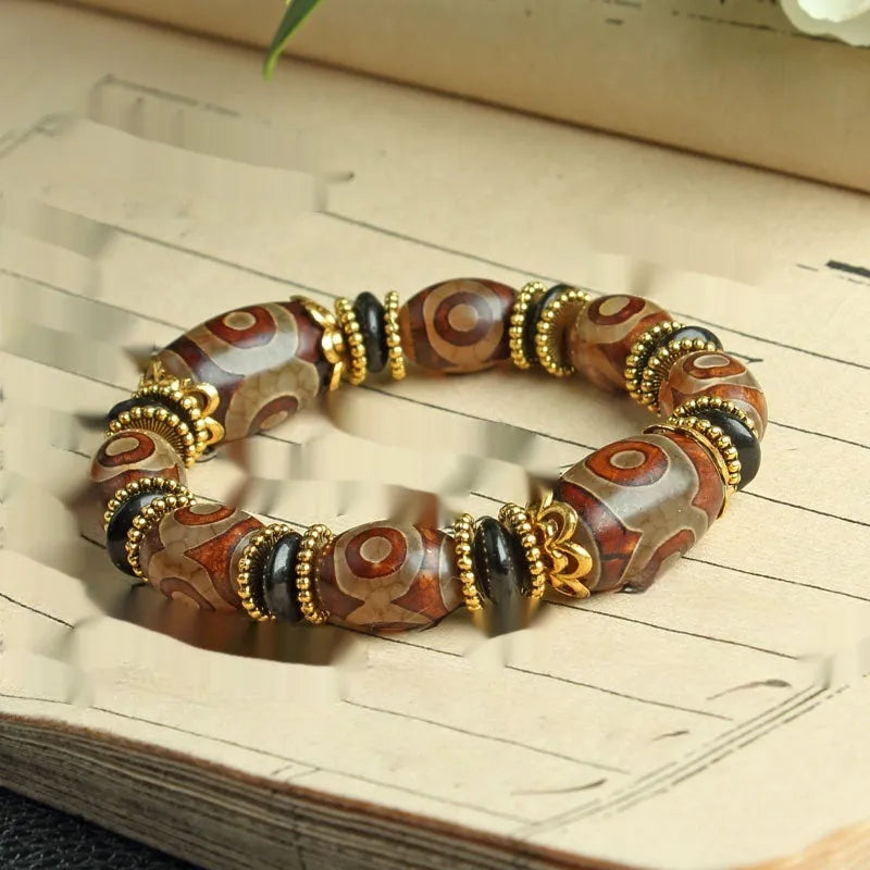 Distressed agate Tibet beads bracelet with three eye dzi design and polished stone beads