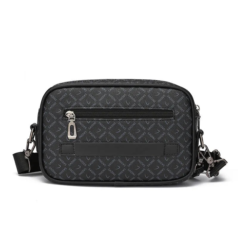 Men's black PU leather messenger bag with a geometric pattern, shown worn crossbody.