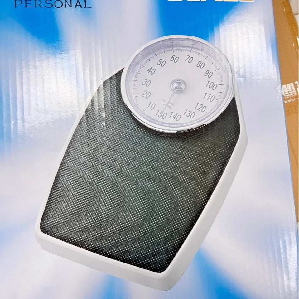 Black mechanical bathroom scale with large dial on a 47x35 cm platform.