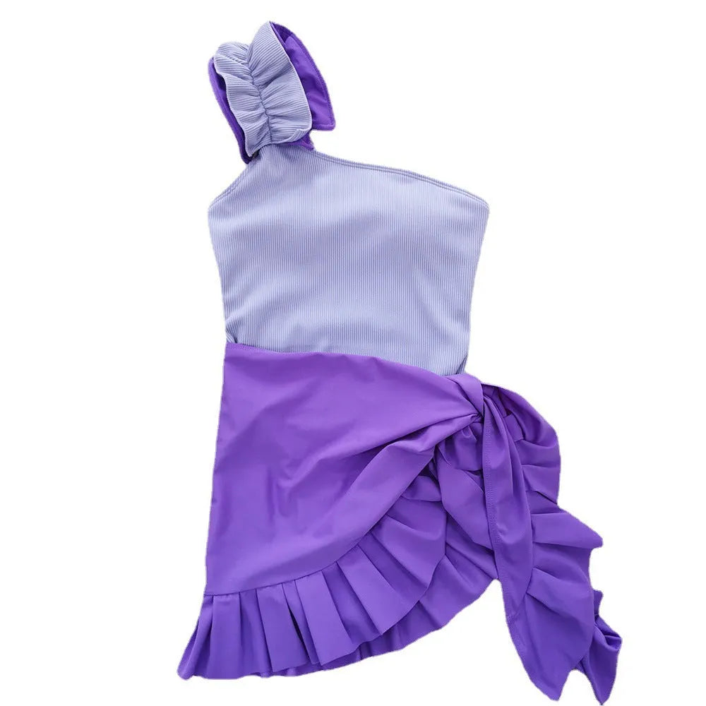 A blue women's one-piece swimsuit with a single suspender strap and a high-waist cut on a mannequin.
