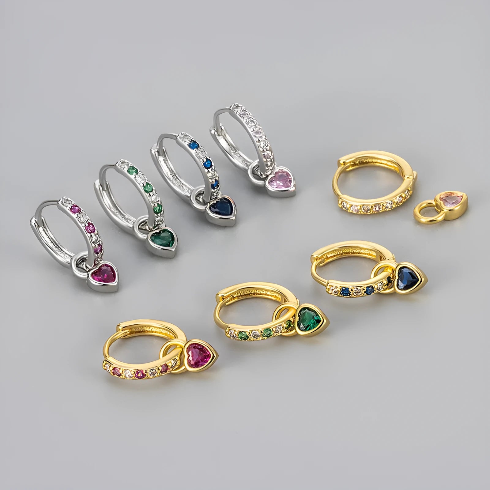 Women's heart-shaped drop earrings with coloured zircon or corundum stone in gold or white gold tone.