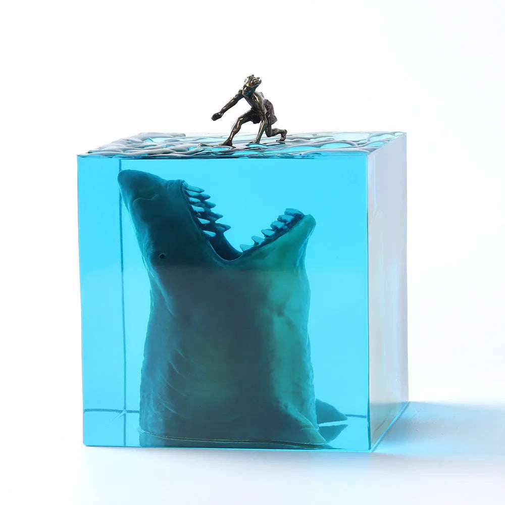 Clear epoxy resin shark surfer night light ornament with LED base in 5cm and 8cm sizes.