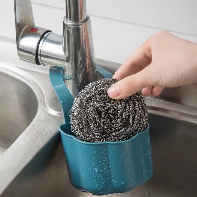 Nordic-style plastic sink drain basket in dark blue on a kitchen countertop.