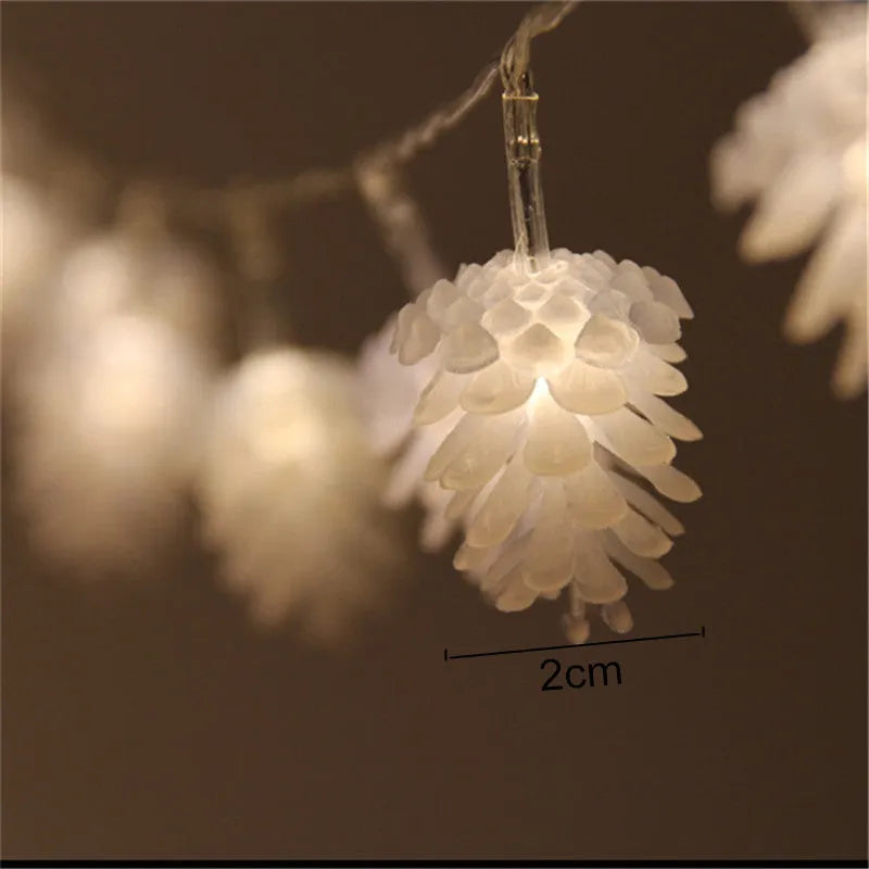 Warm white LED pine cone lights on a string, powered by batteries, for indoor and outdoor decoration.