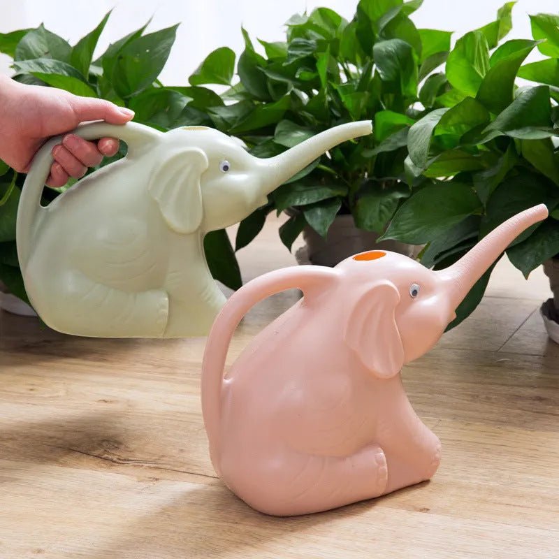 Pink children's watering can shaped like a sitting elephant with a long spout and baby-bottle handle.