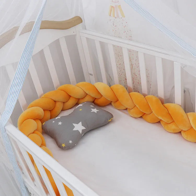 Braided knot style baby cot bumper in spandex crystal velvet fabric, shown in a light grey colour.