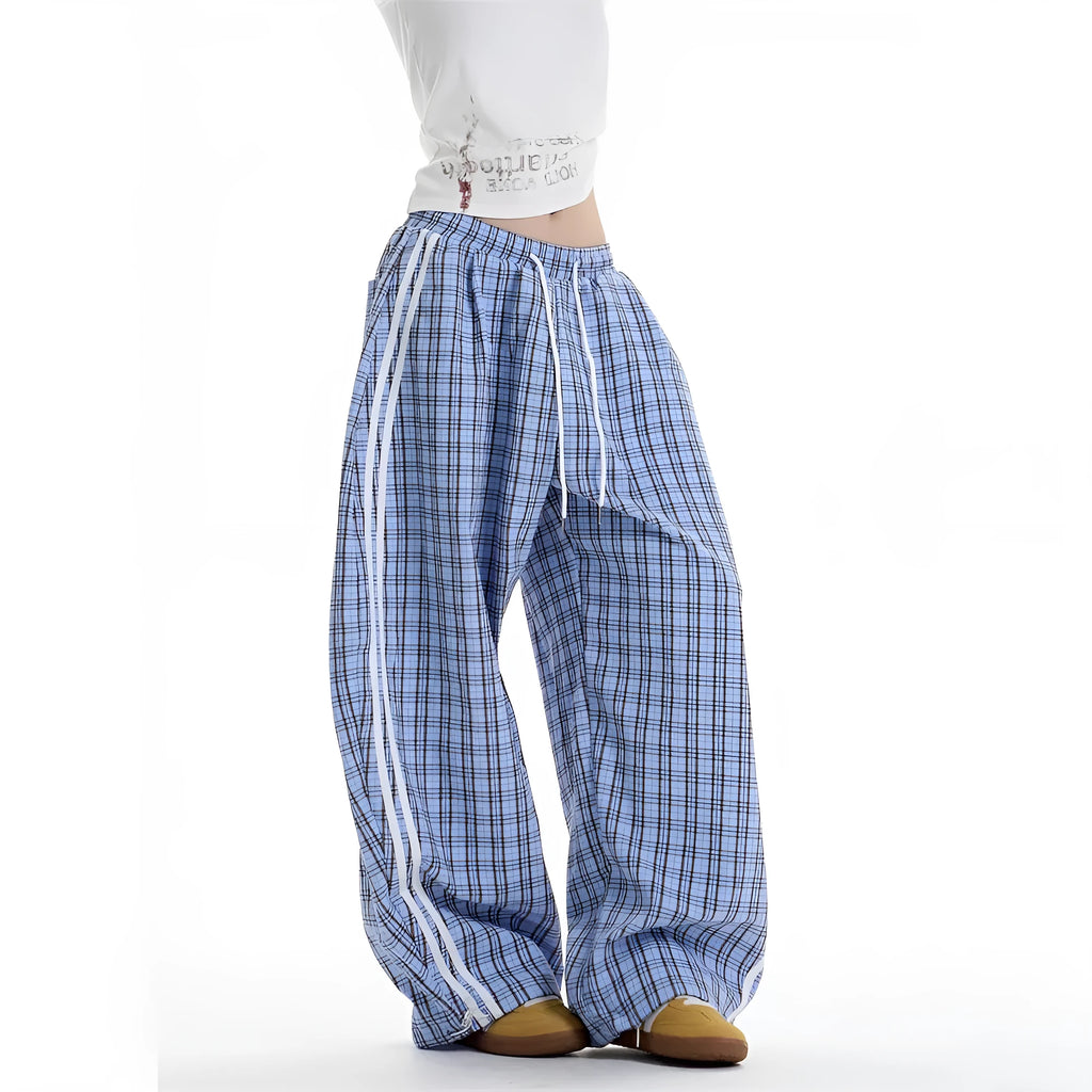Blue loose straight wide leg polyester trousers with pockets and mid-waist design on a model