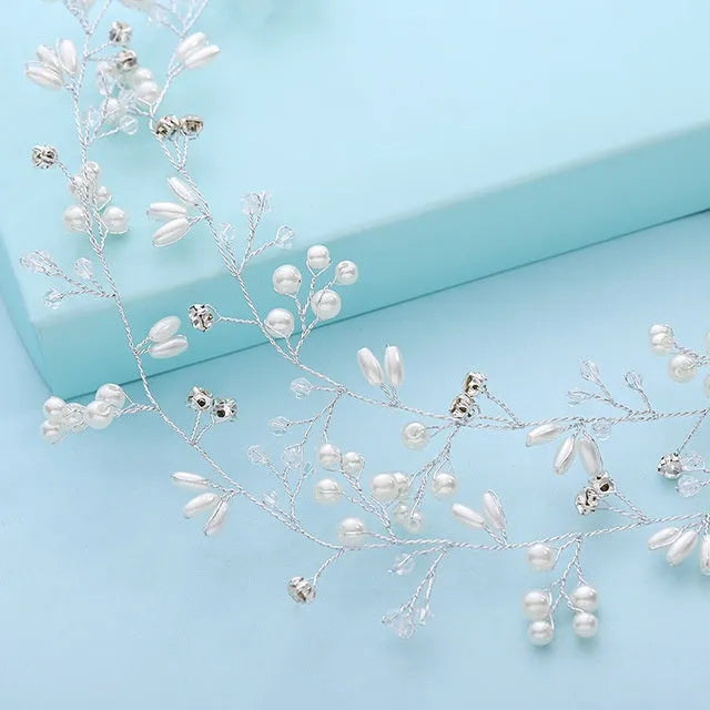 Long silver wire hair band with crystal and pearl decorations for bridal hairstyling.
