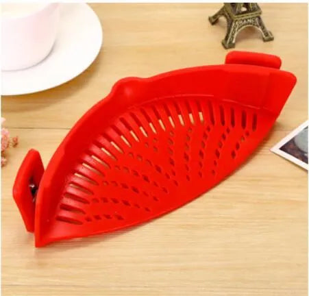 Silicone clip-on kitchen strainer with stainless steel filter mesh attached to a pot rim