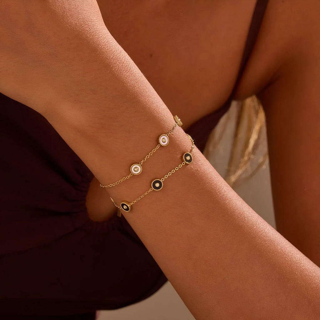 Geometric fritillary design bracelet and necklace set with 18K gold plating on stainless steel.