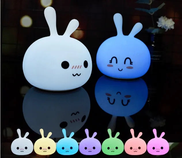 Marshmallow Bunny LED Night Light with 0.4W ABS silicone construction and happy face expression on a bedside table