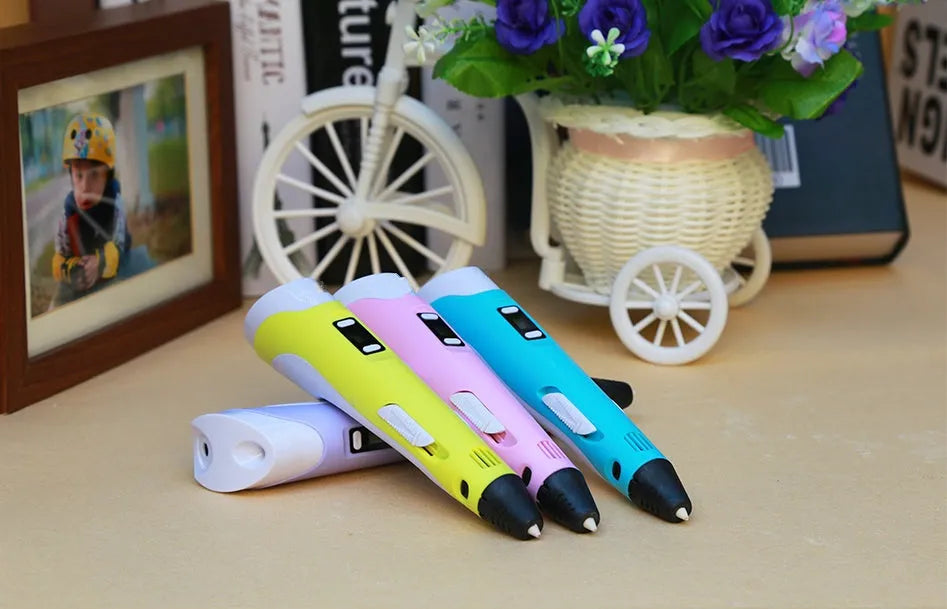 Yellow 3D printing pen with PLA filament spool on a white surface, showing nozzle and controls