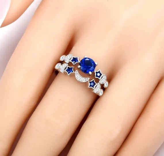 Creative moon ring with blue gemstone inlay on display showing detailed crescent design and stone setting.