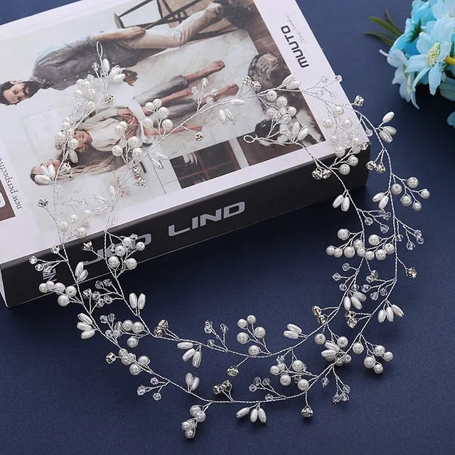 Long silver wire hair band with crystal and pearl decorations for bridal hairstyling.