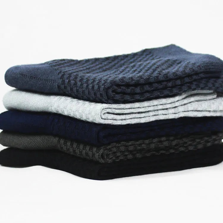 Men's bamboo fibre ankle socks in black with a small square pattern, laid flat.