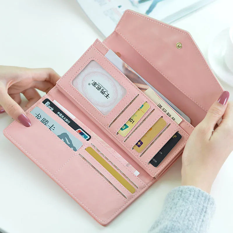 Women's large capacity three-fold PU leather wallet with buckle closure in multiple colours.