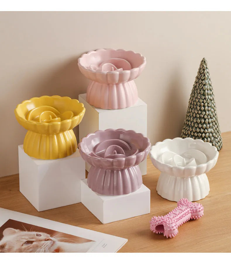 Ceramic slow feed dish with flower pool design and higher edges for cats and small dogs, shown in pink.