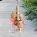 Colourful parrot shredding toy with natural wood and sisal rope measuring 15 by 35 centimetres