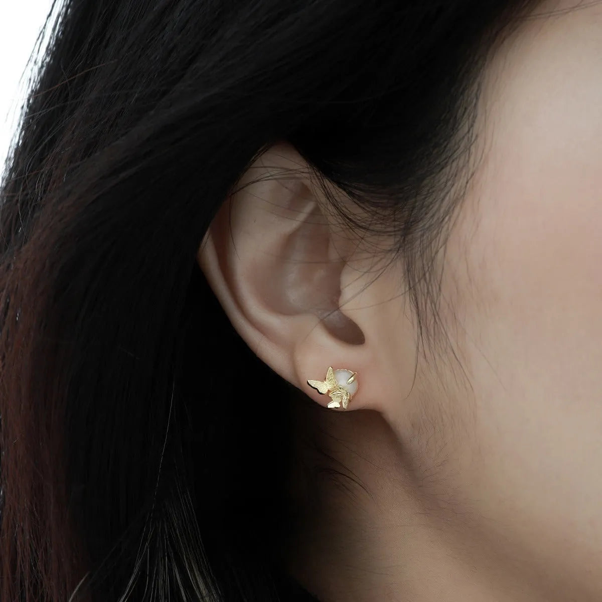 A pair of butterfly-shaped stud earrings in 925 silver with a gold electroplated finish.