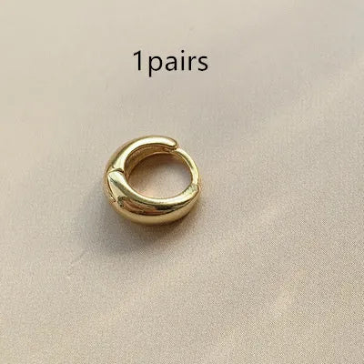 Women's minimalist geometric water drop earrings in gold or silver on a copper base, shown in large, medium, and small sizes.