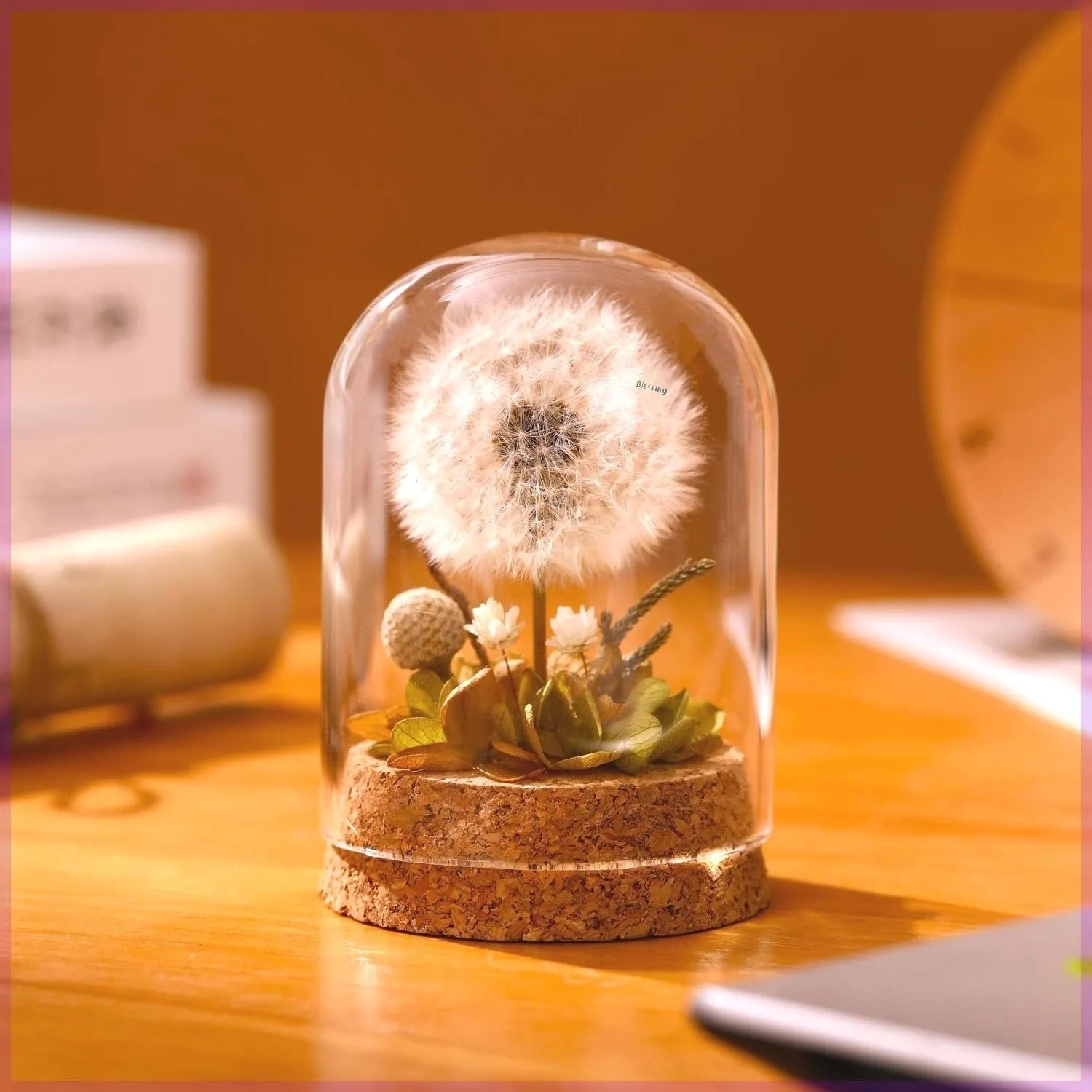 Dandelion-shaped glass night light ornament in gradient colours on wooden surface